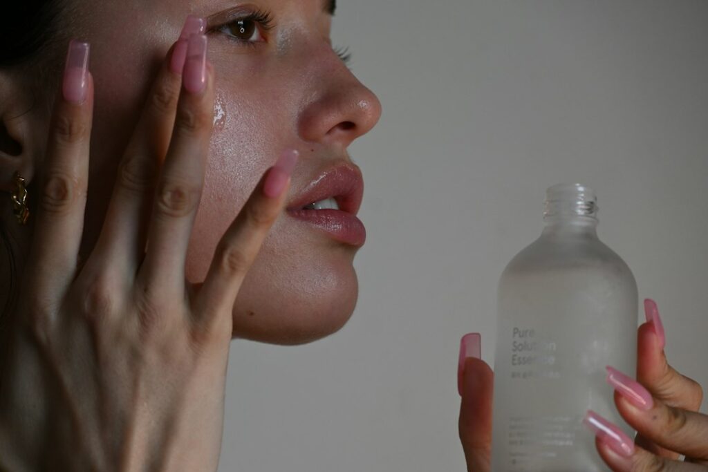 Woman applying facial serum as part of an anti-aging skincare routine