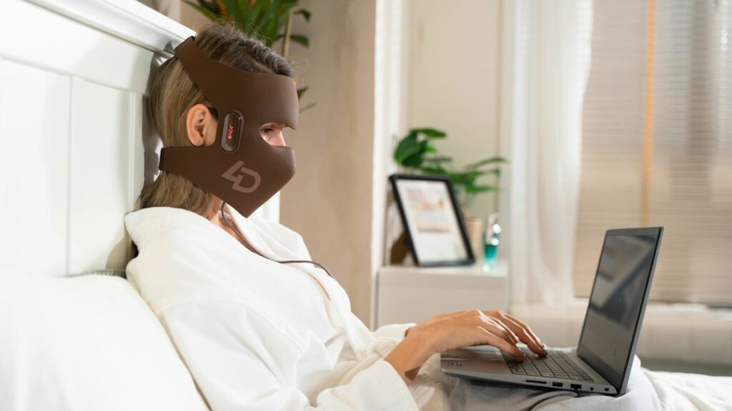 Woman wearing an LED face mask during an at-home skincare routine