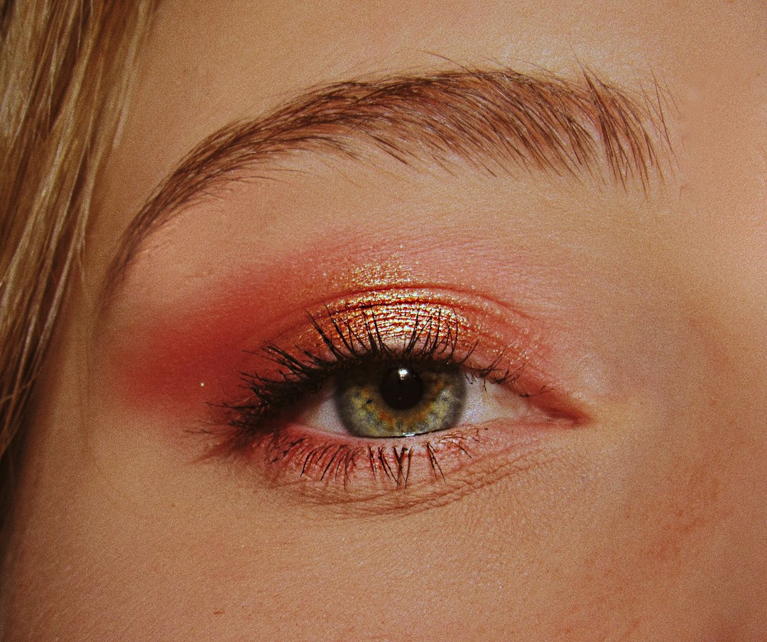 Close-up of pink eyeshadow with gold shimmer on an eyelid