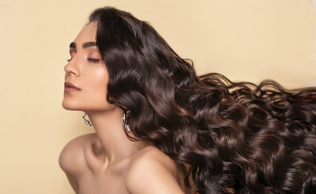 Long dark glossy waves illustrating the fall hair shine routine
