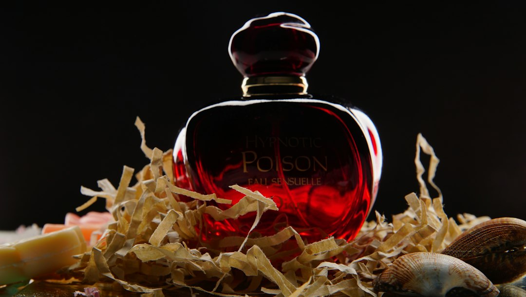 Perfume bottle in a deep red setting for sparkling jam fragrance trend